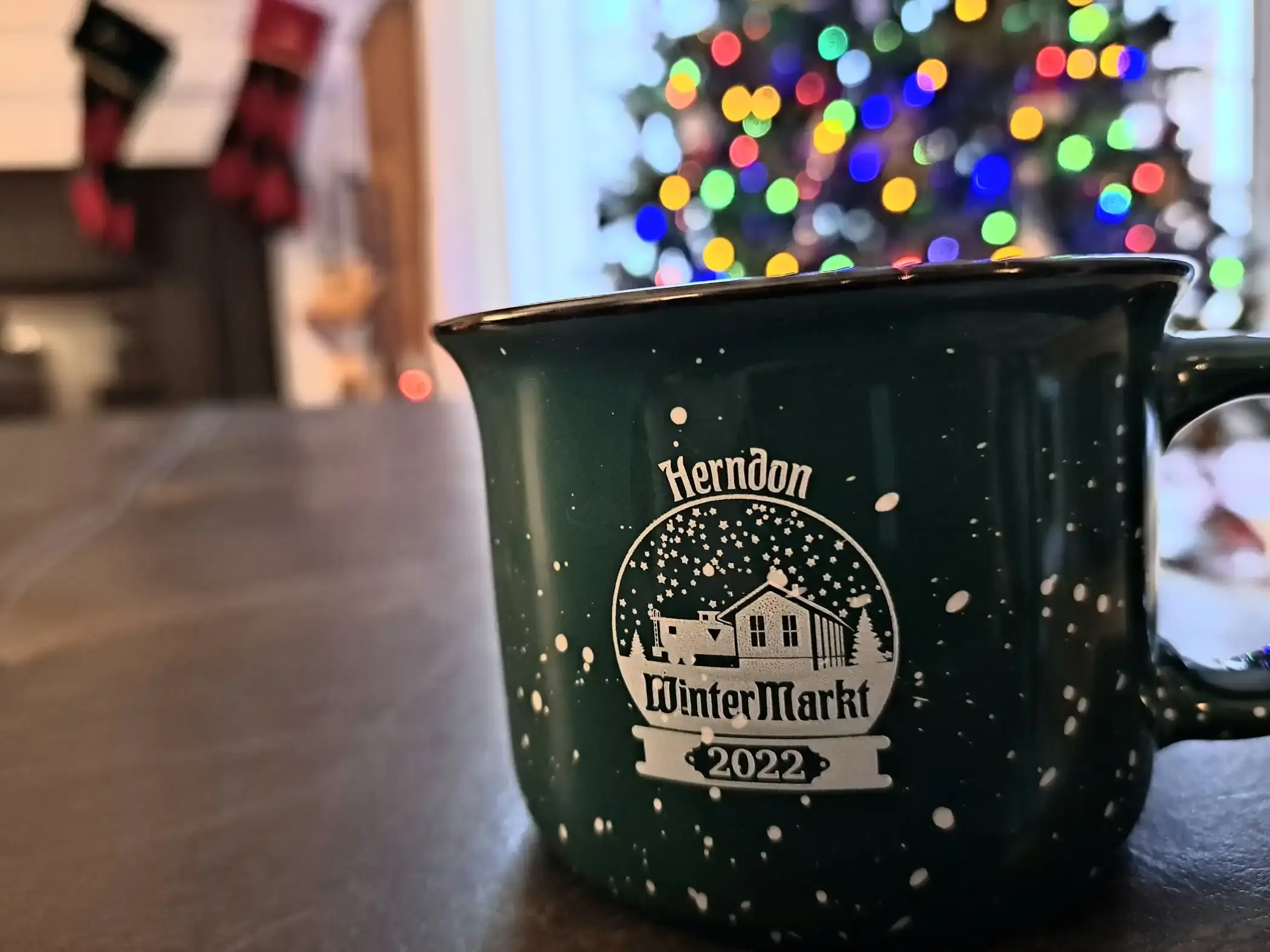 Herndon Winter Markt coffee mug against Christmas decorations