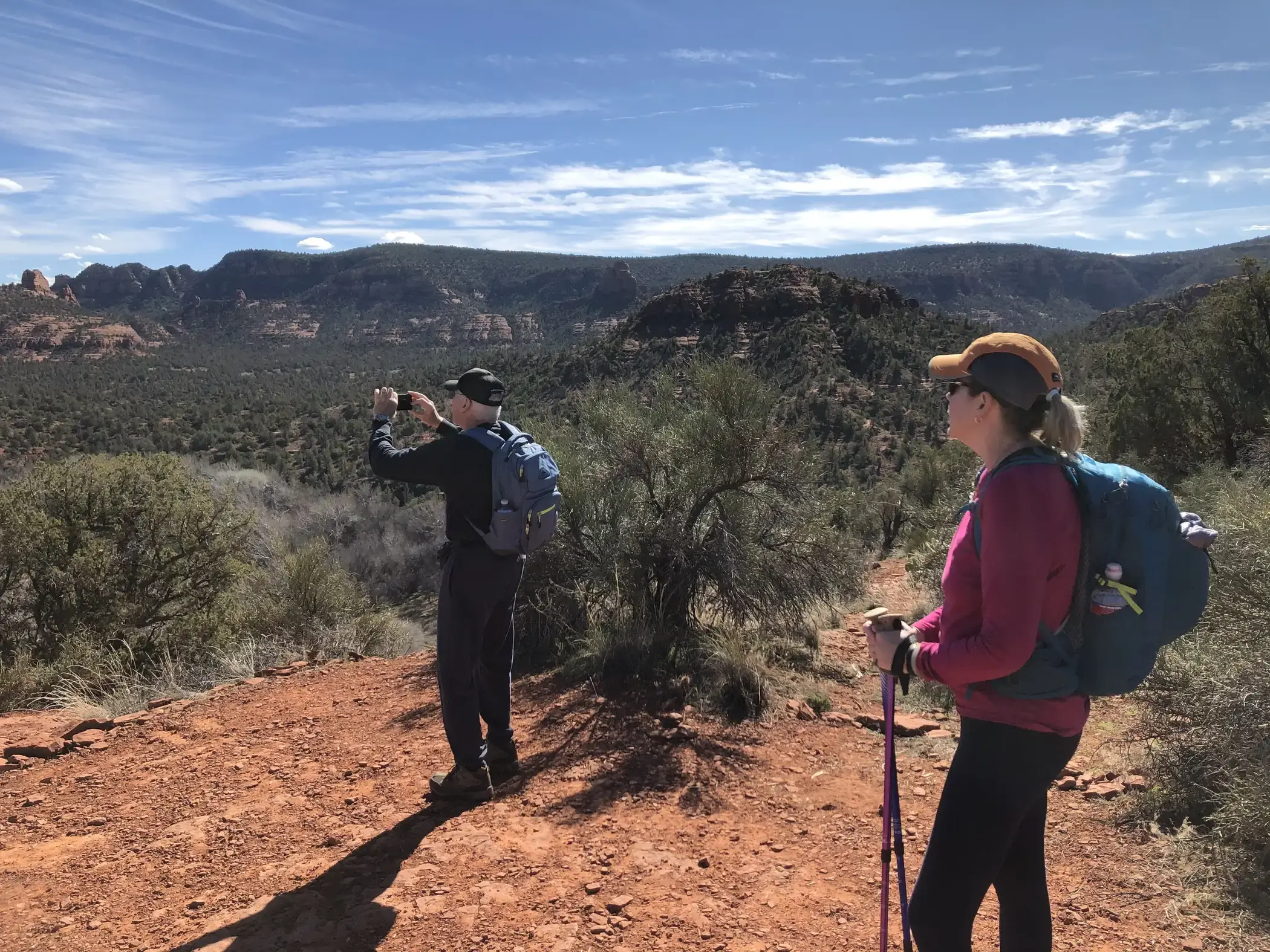A list of the items every hiker should carry with them on their day hikes and why. (10 min. read) Day hikers admire view atop Eagle's Next Trail, Red Rock State Park, Sedona, Arizona