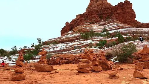 Hikers climb Bell Rock near Village of Oak Creek, Sedona, Arizona